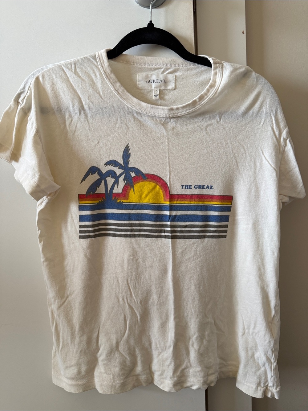 THE GREAT. Off-White Tee with Yellow Sun, Blue Palms & Red Accent